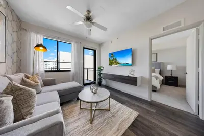 a living room with a couch and a table at The Serenity in DTWN 3 Min From Las Olas in Fort Lauderdale