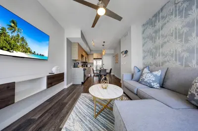 a living room with a couch and a table at Palm Paradise in DTWN 3 Min From Las Olas in Fort Lauderdale
