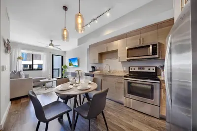 a kitchen and dining room with a table and chairs at Palm Paradise in DTWN 3 Min From Las Olas in Fort Lauderdale