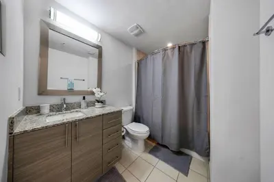 a bathroom with a sink and a toilet and a mirror at Aqua Vista in DTWN 3 Min From Las Olas in Fort Lauderdale