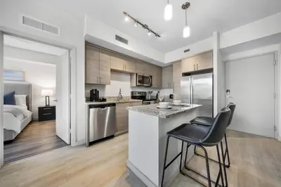 a kitchen with a counter and a bar with chairs at Aqua Vista in DTWN 3 Min From Las Olas in Fort Lauderdale
