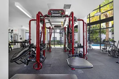 a gym with red equipment and a swimming pool at Aqua Vista in DTWN 3 Min From Las Olas in Fort Lauderdale