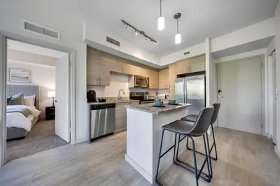 a kitchen and living room with a bed at Coral Haven in DTWN 3 Min From Las Olas in Fort Lauderdale