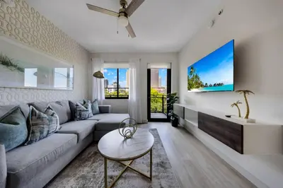 a living room with a couch and a tv at Coral Haven in DTWN 3 Min From Las Olas in Fort Lauderdale