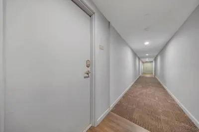 an empty hallway with white walls and a door at Coral Haven in DTWN 3 Min From Las Olas in Fort Lauderdale