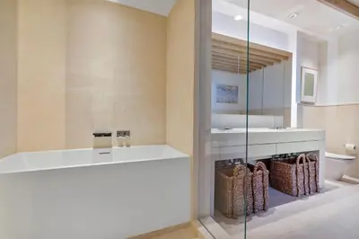 a bathroom with a tub and a sink and a toilet at Villa Royale Residences in Miami Beach