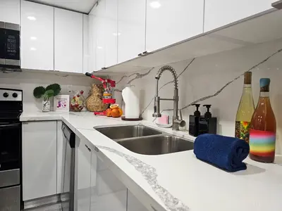 a white kitchen with a sink and a counter top at The Ruby - Hot Tub - King beds - Close to LMC in Fort Lauderdale