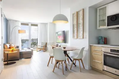 a kitchen and dining room with a table and chairs at 2BR 2BA at Beachwalk on 29 floor Full Equiped in Hallandale Beach