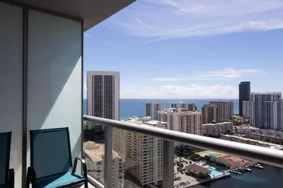 a view of the city from a balcony in a building at Family Beachwalk Studio- 29th floor in Hallandale Beach
