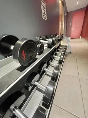 a row of dumbbells lined up in a gym at Family Beachwalk Studio- 29th floor in Hallandale Beach