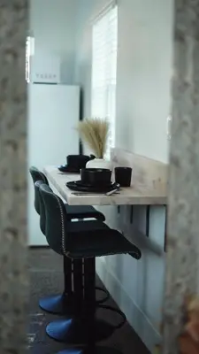 a table with bowls and plates on it in a kitchen at Cozy Miami Home Next to Wynwood & Design District in Miami