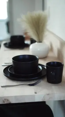 a table with black bowls and utensils on it at Cozy Miami Home Next to Wynwood & Design District in Miami