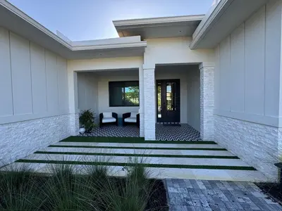 a home with a patio and a house at New Villa Near Hardrock Fll Wboating Near Beach in Fort Lauderdale