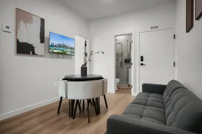 a living room with a couch and a table at Prestige Retreat by Renzzi in Miami