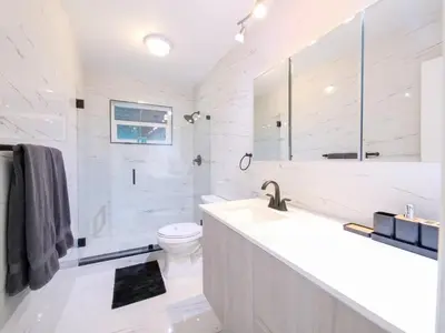 a white bathroom with a sink and a toilet at Luxury,3Bed 2Bath ,Pool,Grill,Parking in Hollywod in Hollywood