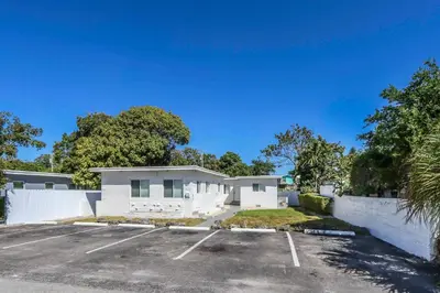 a parking lot in front of a house at Cozy Modern Studio Near Sunny Isles & Bal Harbour in North Miami