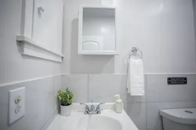 a white bathroom with a sink and a toilet at N. Miami Studio | Stylish Stay Minutes from Ocean in North Miami