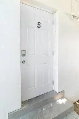 a white door with the number on it at N. Miami Studio | Stylish Stay Minutes from Ocean in North Miami
