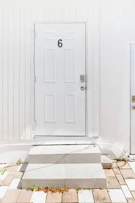 a white door with the number six on it at Spacious North Miami Studio | 2 Queen Beds in North Miami