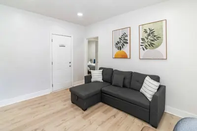 a living room with a couch and a table at Spacious 1BR in North Miami | Near Beach & Dining in North Miami