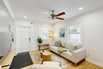 a living room with a couch and a ceiling fan at Palm & Pool Retreat in Fort Lauderdale