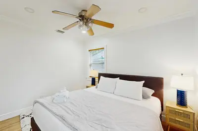 a bedroom with a bed with a ceiling fan at Palm & Pool Retreat in Fort Lauderdale