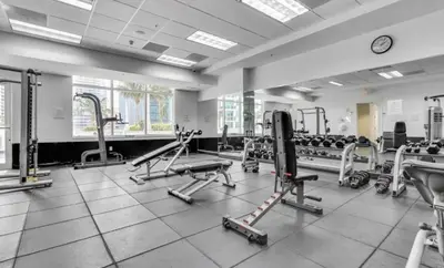 a gym with several treadmills and machines at Skyline with Water views 2 bedroom in Miami