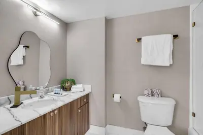 a bathroom with a sink and a toilet and a mirror at Stunning 3B2B with Ocean and City Views - Free Parking in Miami