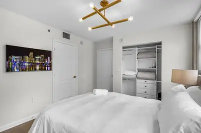 a white bedroom with a bed and a ceiling fan at Stunning 3B2B with Ocean and City Views - Free Parking in Miami