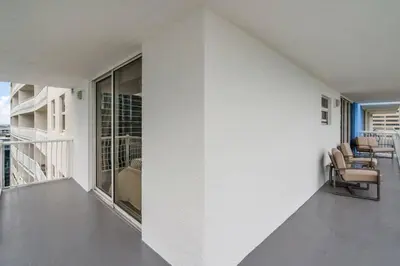 a room with white walls and chairs on a balcony at Stunning 3B2B with Ocean and City Views - Free Parking in Miami