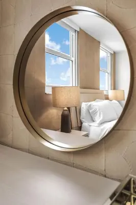 a mirror reflecting a bedroom with a bed and a window at Stunning 3B2B with Ocean and City Views - Free Parking in Miami