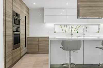 a kitchen with white cabinets and a sink at Miami Modern Heated Pool and Dock in Sunny Isles Beach