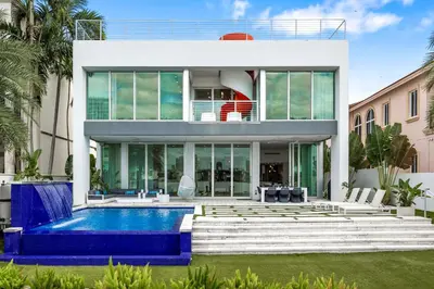 a house with a swimming pool in front of it at Miami Modern Heated Pool and Dock in Sunny Isles Beach