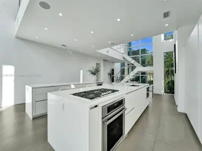 a white kitchen with a stove top oven at Modern waterfront property in Fort Lauderdale