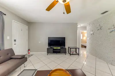 a living room with a couch and a ceiling fan at Fenced-In Yard Home 3 Mi to Hard Rock Stadium! in Miramar