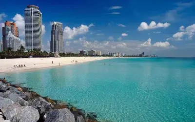 a view of a beach with buildings in the background at Miami Escape Parking Pool Near Wynwood in Miami