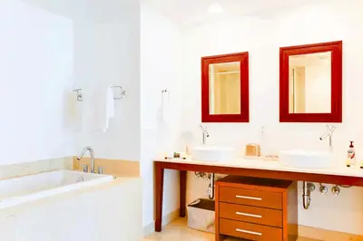a bathroom with two sinks and a bath tub and a tubermott at Luxury Living in Brickell - Stunning City Views in Miami