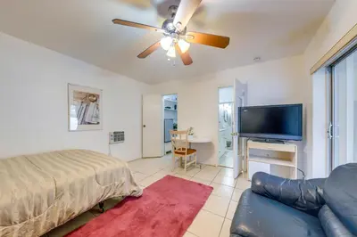 a living room with a couch and a ceiling fan at 8 Mi to Beach! Miramar Guest Suite with Pool Access in Miramar