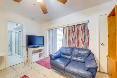 a living room with a leather couch and a television at 8 Mi to Beach! Miramar Guest Suite with Pool Access in Miramar