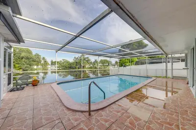 an indoor swimming pool with a large glass ceiling at 5 Mi to Hollywood Blvd! Miramar Apt with Shared Pool in Miramar