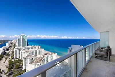 a balcony with a view of the ocean and buildings at Beautiful 1BR Apartment with Ocean View Balcony in Hollywood