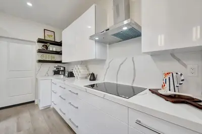 a white kitchen with white cabinets and a sink at New 4BR Upscale Family Haven in Fort Lauderdale