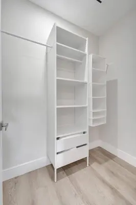 a white closet with white shelves in a room at New 4BR Upscale Family Haven in Fort Lauderdale