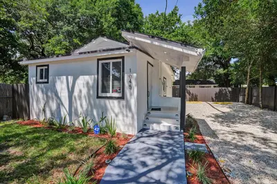 a small white tiny house in a yard at Miami Heart Retreat, Stylish & Central With Games in Miami