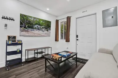 a living room with a couch and a table at Heart of Miami Oasis, Modern, Steps from It All in Miami