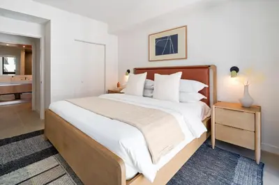 a bedroom with a large bed and a bathroom at The Crosby Miami World Center in Miami