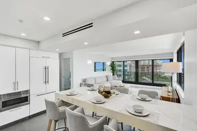 a kitchen and dining room with a table and chairs at Oceanfront Luxury 3BR 3BA Condo with Resort Pools Gym and Sauna 902 in Miami Beach
