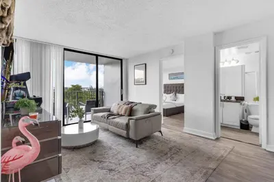 a living room with a couch and a pink flamingo at Urban Escape 2 Bed Unit In Miami near Whole Foods in North Miami