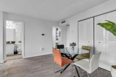 a dining room with a glass table and chairs at Urban Escape 2 Bed Unit In Miami near Whole Foods in North Miami