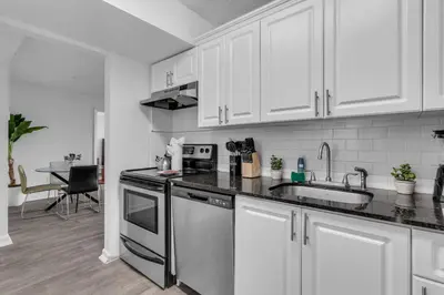 a kitchen with white cabinets and a sink at Urban Escape 2 Bed Unit In Miami near Whole Foods in North Miami